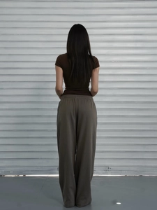 Back view of a slim fit brown short sleeve T-shirt and olive wide leg pants for women