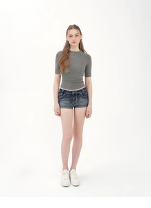 Front full view of a fitted grey short-sleeve knit top with frayed blue denim shorts