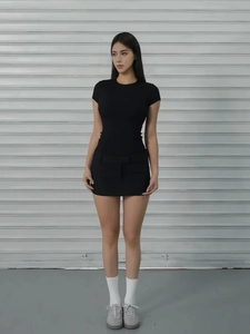 Minimalist black slim fit crew neck short sleeve sports t-shirt worn with a mini skirt