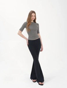 Slim fit grey knitted top paired with high waist black flare pants for a casual style