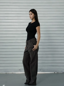 Side view of model wearing a black slim fit T-shirt and grey wide-leg cargo pants
