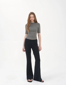Detail of grey slim-fit turtleneck top and black flare trousers with drawstring