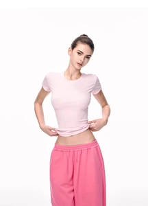 Detail of pink ribbed short sleeve t-shirt showing stretch fabric and slim fit design