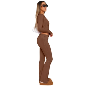 Close-up of brown long sleeve crop top and matching high-waisted flared trousers set