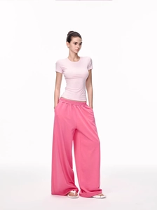 Detail of light pink slim fit t-shirt paired with dark pink wide-leg sweatpants on model