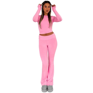 Detail of pink two-piece sports set with cropped long sleeve top and flared yoga pants