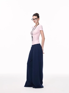 Detailed view of pink slim fit T-shirt paired with navy high waist wide leg sweatpants