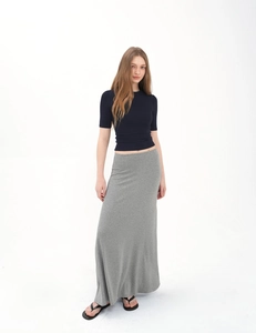 Full view of a slim navy short-sleeve top and long grey knitted maxi skirt set