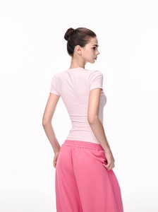 Detail view of pink slim fit short sleeve t-shirt and wide leg trousers set for women