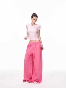 Close-up of pink slim-fit short-sleeve T-shirt paired with matching wide-leg sweatpants