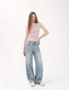 Slim fit pink short sleeve tee paired with wide leg vintage blue denim jeans for women