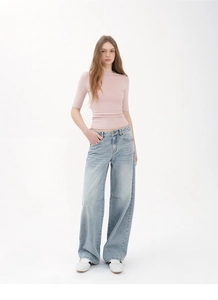 Slim fit pink half-sleeve top paired with high-waisted wide leg light blue jeans
