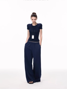 Detail of navy blue slim fit T-shirt and drawstring wide-leg knit trousers set