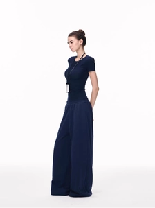 Detail view of navy blue crewneck slim fit T-shirt and wide-leg trousers on model