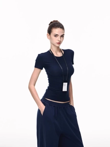 Detailed shot of dark blue slim-fit round neck T-shirt and high-waisted wide-leg trousers