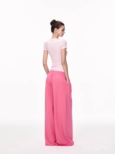 Detail view of pink slim fit crewneck T-shirt paired with matching wide leg sweatpants