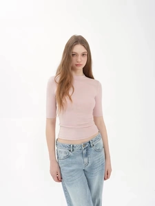 Slim fit pink mock neck ribbed knit top paired with vintage wash jeans for women