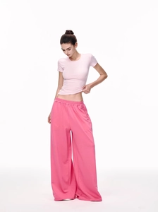 Detail of slim fit pink short sleeve T-shirt paired with wide leg lounge pants