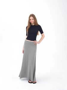 Slim fit black short sleeve t-shirt paired with a long grey skirt for casual women outfit