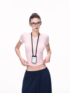 Vertical black ID card holder with matching lanyard worn by model in pink tee