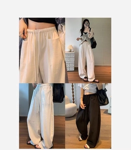 Detail view of high waist wide leg pants with drawstring waist and deep side pockets