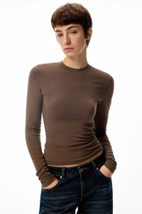 Detail showing the fit and texture of a dark brown slim-fit long-sleeve crewneck t-shirt