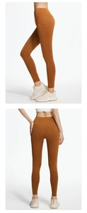Detail view of high-waist yoga leggings in burnt orange with side pockets and bum lift