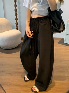 Women's black wide-leg trousers with elastic drawstring waist and side cargo pockets