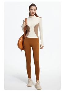 Detail view of high waist caramel yoga leggings and zip-up slim fit athletic jacket