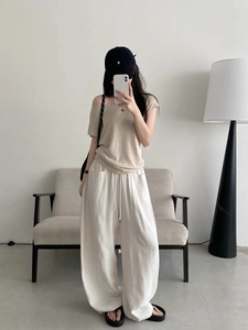 Women's minimalist loose white drawstring wide-leg pants with beige off-shoulder top outfit