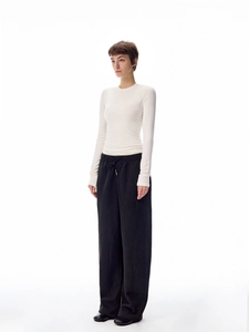 Close-up of ivory long-sleeve slim top with drawstring wide-leg trousers