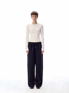 Slim fit white crew neck long sleeve top paired with black drawstring wide leg pants