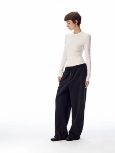 Detailed texture of white slim crew neck long sleeve top and black drawstring sweatpants