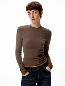 Detail of mocha brown long sleeve slim fit crew neck knitted top paired with jeans
