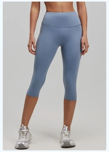 Detail view of high waisted dusty blue yoga leggings with reinforced flatlock stitching