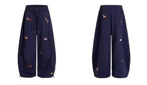 Detail of dachshund embroidery on navy wide-leg sweatpants with adjustable drawstrings