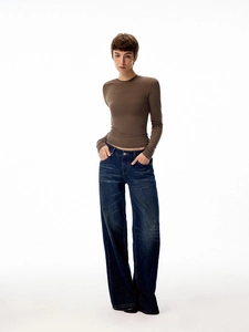 Close-up of brown slim fit long sleeve top and dark blue wide-leg denim jeans