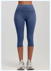 Front view of high waist blue cropped yoga leggings showing elastic seamless waistband