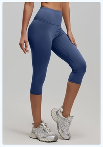 Detail of high-waist yoga capris in dusty blue showing stretch fabric and seam quality