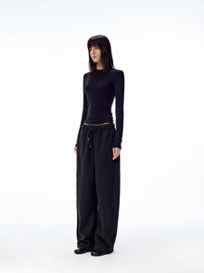Close-up of black long sleeve top and wide leg joggers with drawstring detail