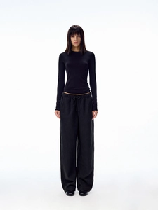 Detail of slim fit long sleeve top and high waist drawstring wide leg lounge pants