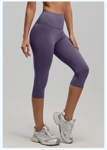 Detail of high-waist purple cropped yoga leggings featuring wide waistband for tummy control