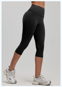 Side view of black high-waisted cropped yoga leggings showing elastic slim fit design