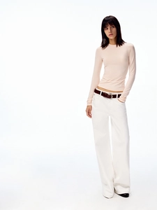 Detail of slim-fit pink long sleeve top with crew neck and ribbed texture