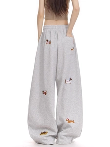 Light gray wide leg sweatpants featuring detailed sausage dog embroidery on soft cotton fabric