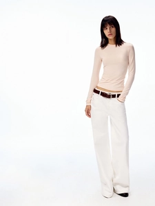 Slim fit light pink long sleeve crewneck top paired with white wide-leg trousers