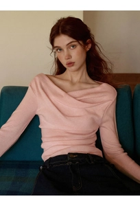 Detail of slim fit pink long sleeve top with unique criss-cross off-shoulder neckline design