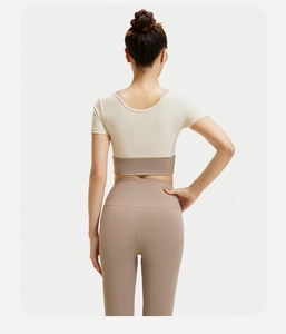 Detailweergave van de achterkant van een tweedelige yogaset met beige top en kaki legging
