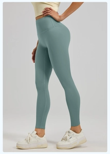 Close-up of high-waist yoga pants in sage green showing seamless texture and squat-proof fabric
