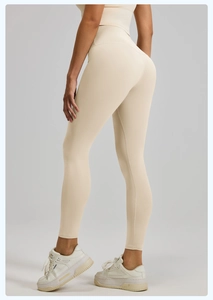 Detail view of high-waisted yoga pants in cream fabric with seamless stitching details